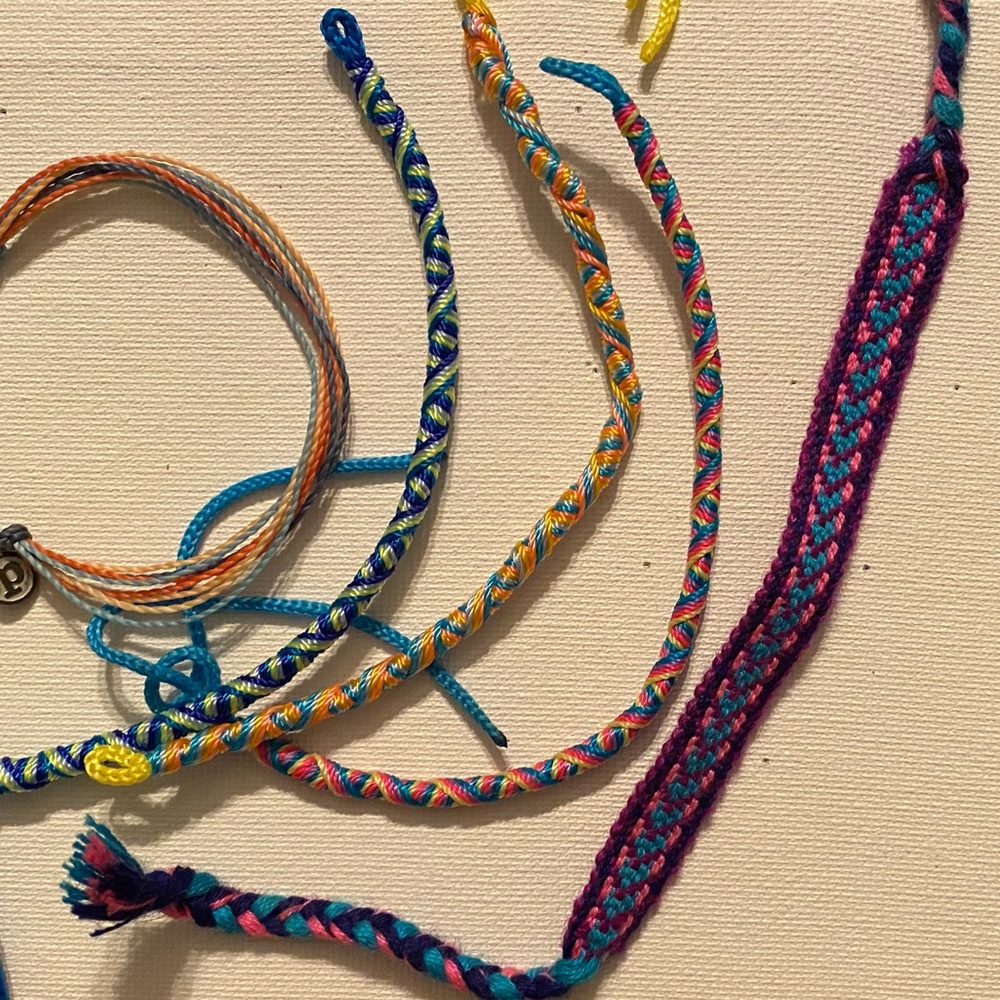 Lot of friendship bracelets and pura vida